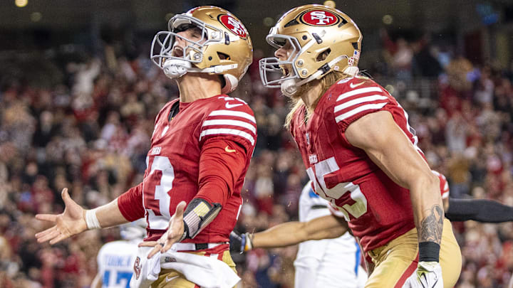 December 30, 2024; Santa Clara, California, USA; San Francisco 49ers quarterback Brock Purdy (13) celebrates with tight end George Kittle (85) after scoring a touchdown against the Detroit Lions during the second quarter at Levi's Stadium. Mandatory Credit: Kyle Terada-Imagn Images