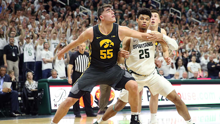 Feb 25, 2020; East Lansing, Michigan, USA; Iowa Hawkeyes center Luka Garza (55) and Michigan State Spartans forward Malik Hall (25) fight for position during the second half a game at the Breslin Center. Mandatory Credit: Mike Carter-Imagn Images