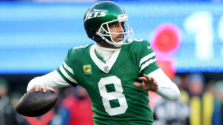 Dec 22, 2024; East Rutherford, New Jersey, USA; New York Jets quarterback Aaron Rodgers (8) drops back to pass against the Los Angeles Rams during the fourth quarter at MetLife Stadium. 