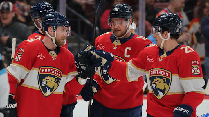 Mar 28, 2025; Sunrise, Florida, USA; Florida Panthers center Sam Bennett (9) celebrates with right wing Mackie Samoskevich (25) and center Aleksander Barkov (16) after scoring against the Utah Hockey Club during the second period at Amerant Bank Arena. Mandatory Credit: Sam Navarro-Imagn Images