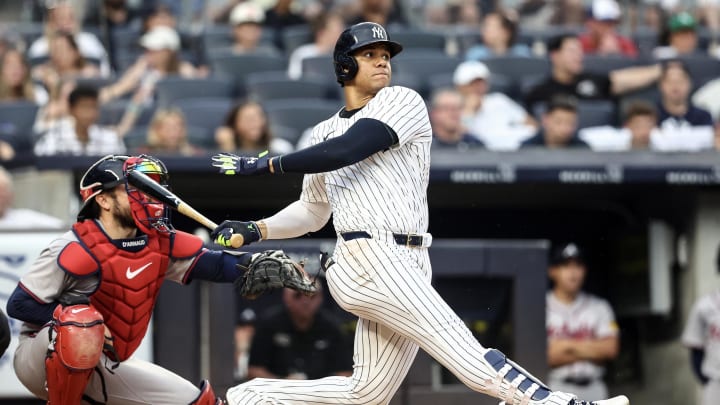 Jun 22, 2024; Bronx, New York, USA; New York Yankees right fielder Juan Soto (22) hits a single against the Atlanta Braves in the third inning at Yankee Stadium. 