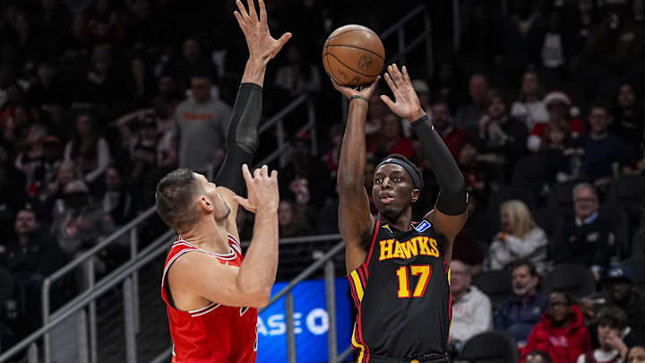 Dec 21, 2025; Atlanta, Georgia, USA; Atlanta Hawks forward Onyeka Okongwu (17) shoots against Chicago Bulls center Nikola Vucevic (9) during the first half at State Farm Arena. Mandatory Credit: Dale Zanine-Imagn Images