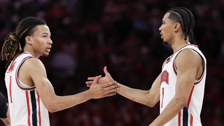 Mar 4, 2026; Houston, Texas, USA; Houston Cougars guard Kingston Flemings (4) shakes hands with  guard Milos Uzan (7) against the Baylor Bears in the second half at Fertitta Center. Mandatory Credit: Thomas Shea-Imagn Images