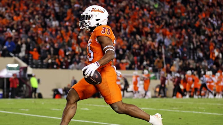 Oct 17, 2024; Blacksburg, Virginia, USA; Virginia Tech Hokies running back Bhayshul Tuten (33) scores a touchdown during the fourth quarter against the Boston College Eagles at Lane Stadium. Mandatory Credit: Peter Casey-Imagn Images