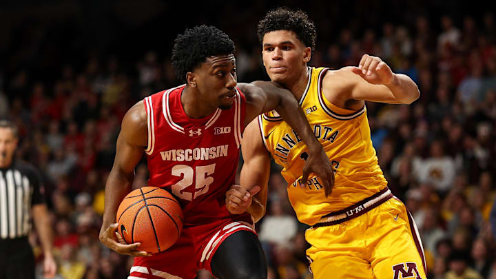 Jan 13, 2026; Minneapolis, Minnesota, USA; Wisconsin Badgers guard John Blackwell (25) works around Minnesota Golden Gophers guard Isaac Asuma (1) during the second half at Williams Arena.