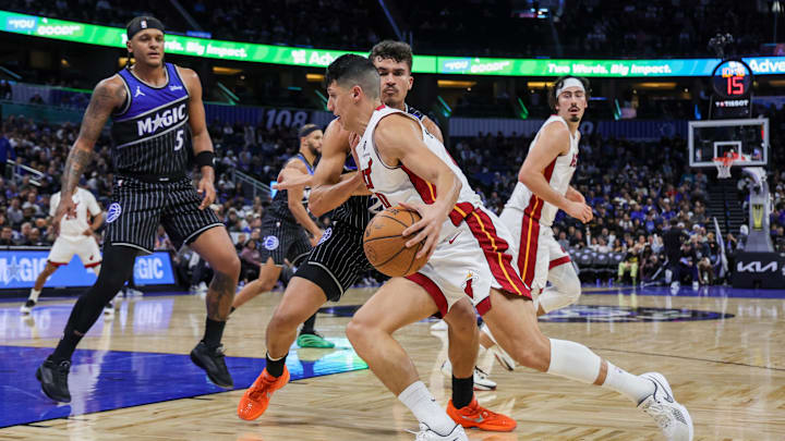 Dec 9, 2025; Orlando, Florida, USA; Miami Heat forward Simone Fontecchio (0) drives around Orlando Magic forward Tristan da Silva (23) during the second quarter at Kia Center. Mandatory Credit: Mike Watters-Imagn Images