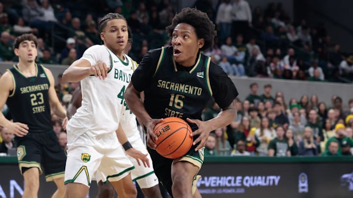 Dec 2, 2025; Waco, Texas, USA;  Sacramento State Hornets guard Prophet Johnson (16) drives to the basket against Baylor Bears guard Cameron Carr (43) during the first half at Paul and Alejandra Foster Pavilion. Mandatory Credit: Chris Jones-Imagn Images