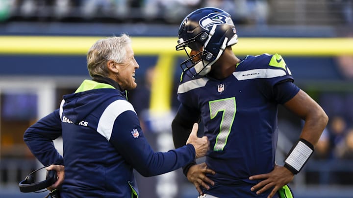 Jan 1, 2023; Seattle, Washington, USA; Seattle Seahawks head coach Pete Carroll, left, talks with quarterback Geno Smith (7) during a fourth-quarter timeout against the New York Jets at Lumen Field.