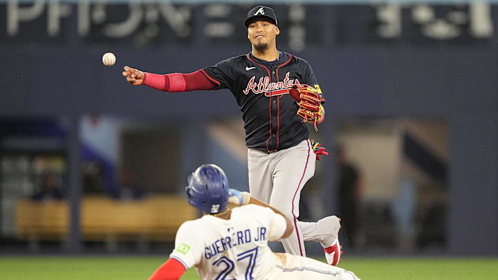 Apr 16, 2025; Toronto, Ontario, CAN; Atlanta Braves shortstop Orlando Arcia (11) turns a double play against Toronto Blue Jays first baseman Vladimir Guerrero (27) and designated hitter Anthony Santander (not pictured) during the seventh inning at Rogers Centre. Mandatory Credit: John E. Sokolowski-Imagn Images Apr 16, 2025; Toronto, Ontario, CAN; Atlanta Braves shortstop Orlando Arcia (11) turns a double play against Toronto Blue Jays first baseman Vladimir Guerrero (27) and designated hitter Anthony Santander (not pictured) during the seventh inning at Rogers Centre. Mandatory Credit: John E. Sokolowski-Imagn Images