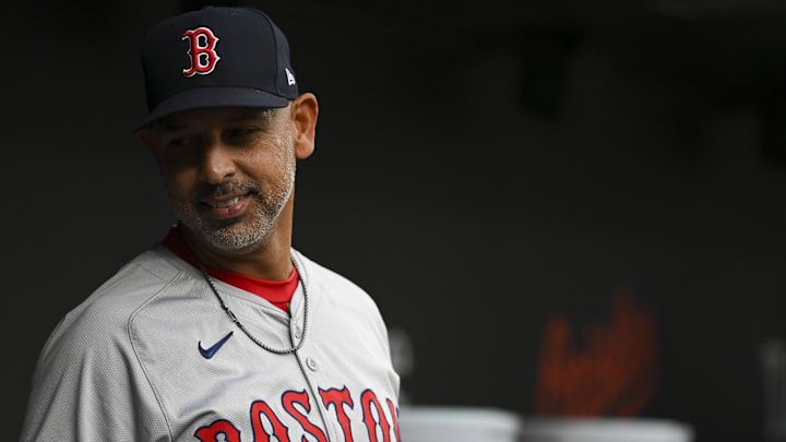 Boston Red Sox manager Alex Cora (13) stands in the dugout during the first inning of the game against the Baltimore Orioles at Oriole Park at Camden Yards.