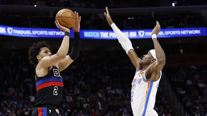 Mar 15, 2025; Detroit, Michigan, USA;  Detroit Pistons guard Cade Cunningham (2) shoots on Oklahoma City Thunder guard Shai Gilgeous-Alexander (2) in the first half at Little Caesars Arena. Mandatory Credit: Rick Osentoski-Imagn Images