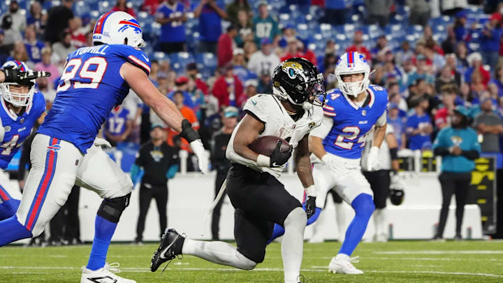 Sep 23, 2024; Orchard Park, New York, USA; Jacksonville Jaguars running back Travis Etienne Jr. (1) runs against the Buffalo Bills during the second half at Highmark Stadium. 