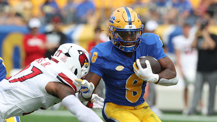 Sep 27, 2025; Pittsburgh, Pennsylvania, USA; Pittsburgh Panthers running back Juelz Goff (8) runs the ball against Louisville Cardinals defensive back JoJo Evans Jr. (27) during the first quarter at Acrisure Stadium. Mandatory Credit: Charles LeClaire-Imagn Images Sep 27, 2025; Pittsburgh, Pennsylvania, USA; Pittsburgh Panthers running back Juelz Goff (8) runs the ball against Louisville Cardinals defensive back JoJo Evans Jr. (27) during the first quarter at Acrisure Stadium. Mandatory Credit: Charles LeClaire-Imagn Images