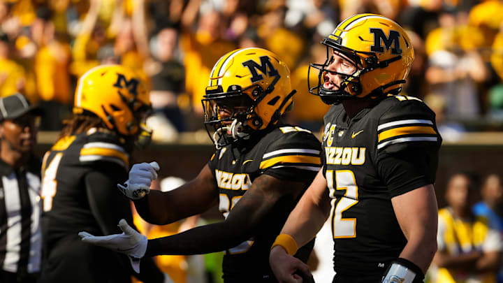Oct 19, 2024; Columbia, Missouri, USA; Missouri Tigers quarterback Brady Cook (12) celebrates with teammates after converting a two-point conversion during the second half against the Auburn Tigers at Faurot Field at Memorial Stadium. Mandatory Credit: Jay Biggerstaff-Imagn Images
