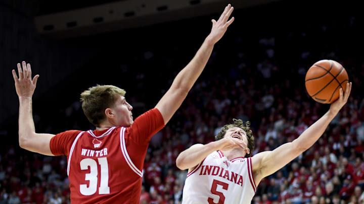 Feb 7, 2026; Bloomington, Indiana, USA; Indiana Hoosiers guard Conor Enright (5) shoots past Wisconsin Badgers forward Nolan Winter (31) during the first half at Simon Skjodt Assembly Hall. Mandatory Credit: Robert Goddin-Imagn Images