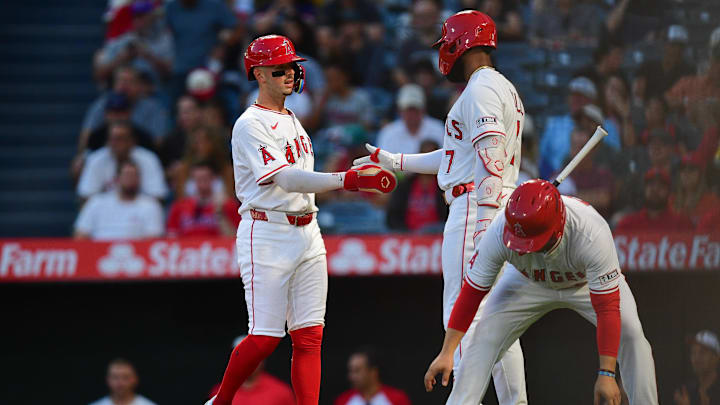 Sep 5, 2025; Anaheim, California, USA; Los Angeles Angels shortstop Zach Neto (9) is greeted by right fielder Jo Adell (7) after scoring a run on bases loaded walk againt the Athletics during the first inning at Angel Stadium. Mandatory Credit: Gary A. Vasquez-Imagn Images
