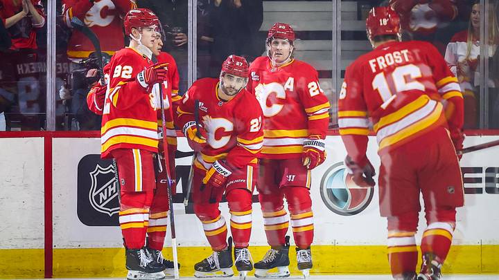 Mar 28, 2026; Calgary, Alberta, CAN; Calgary Flames right wing Matt Coronato (27) celebrates his goal with teammates against the Vancouver Canucks during the first period at Scotiabank Saddledome. Mandatory Credit: Sergei Belski-Imagn Images