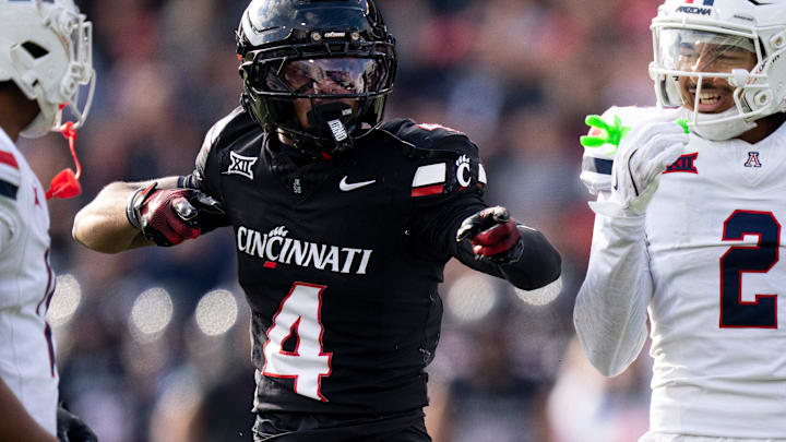 Cincinnati Bearcats wide receiver Cyrus Allen (4) gestures for a first down as Arizona Wildcats linebacker Jabari Mann (11) and Arizona Wildcats defensive back Treydan Stukes (2) react in the third quarter of the NCAA football game at Nippert Stadium in Cincinnati on Nov. 15, 2025.