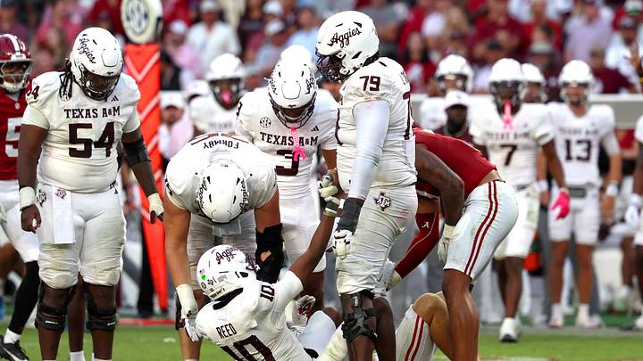Oct 24, 2026; Tuscaloosa, Alabama, USA; Texas A&M Aggies quarterback Marcel Reed (10) is helped up by teammates during the fourth quarter against the Alabama Crimson Tide at Saban Field at Bryant-Denny Stadium. Mandatory Credit: David Leong-Imagn Images