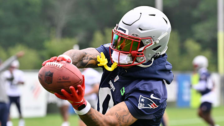 Jun 9, 2025; Foxborough, MA, USA; New England Patriots cornerback Christian Gonzalez (0) catches the ball during minicamp at Gillette Stadium. Mandatory Credit: Eric Canha-Imagn Images