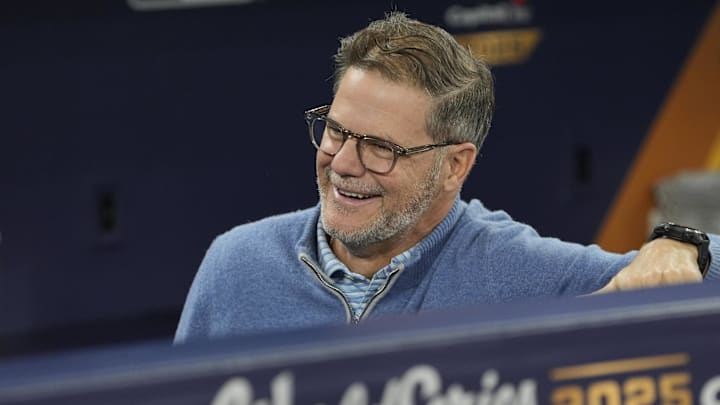Toronto Blue Jays general manager Ross Atkins in dugout wearing blue sweater