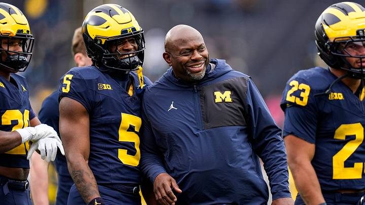 Michigan running backs coach Tony Alford, center, talks to running back Savion Hiter (5) before the spring game at Michigan Stadium in Ann Arbor on Saturday, April 18, 2026.