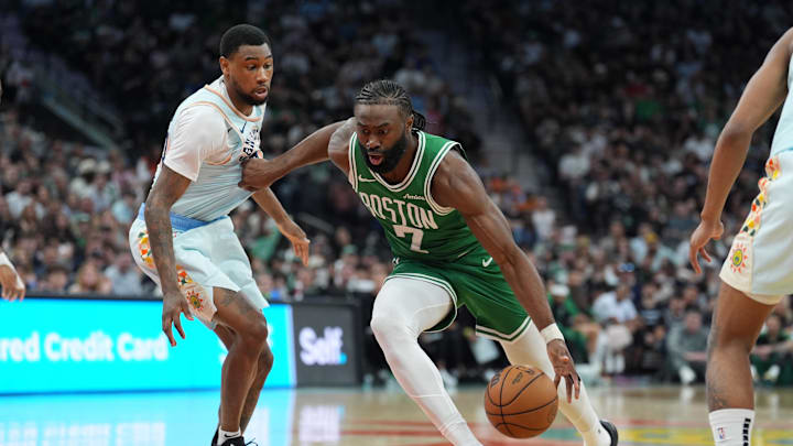 Mar 29, 2025; San Antonio, Texas, USA; Boston Celtics guard Jaylen Brown (7) dribbles past San Antonio Spurs guard Blake Wesley (14) in the second half at Frost Bank Center. Mandatory Credit: Daniel Dunn-Imagn Images