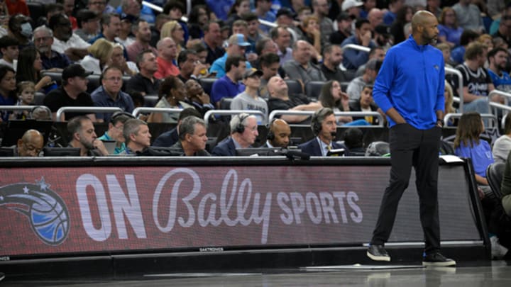 Orlando Magic head coach Jamahl Mosley stands next to an advertisement for Bally Sports during the first half of the team's NBA game against the Detroit Pistons.