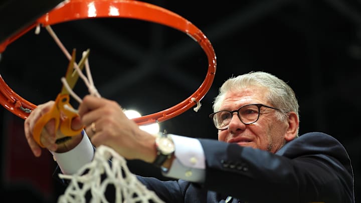Apr 6, 2025; Tampa, FL, USA; Connecticut Huskies head coach Geno Auriemma cuts off the net after the national championship of the women's 2025 NCAA tournament against the South Carolina Gamecocks at Amalie Arena. Mandatory Credit: Nathan Ray Seebeck-Imagn Images Apr 6, 2025; Tampa, FL, USA; Connecticut Huskies head coach Geno Auriemma cuts off the net after the national championship of the women's 2025 NCAA tournament against the South Carolina Gamecocks at Amalie Arena. Mandatory Credit: Nathan Ray Seebeck-Imagn Images