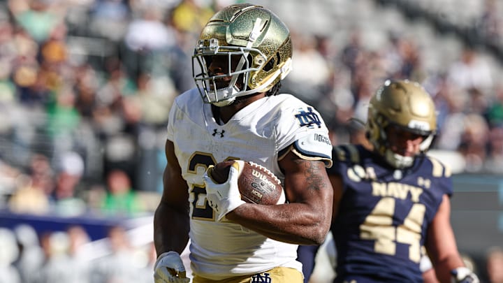 Oct 26, 2024; East Rutherford, New Jersey, USA; Notre Dame Fighting Irish running back Kedren Young (21) celebrates a rushing touchdown during the second half against the Navy Midshipmen at MetLife Stadium. Oct 26, 2024; East Rutherford, New Jersey, USA; Notre Dame Fighting Irish running back Kedren Young (21) celebrates a rushing touchdown during the second half against the Navy Midshipmen at MetLife Stadium.