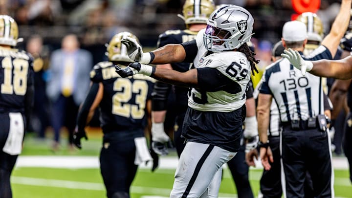 Dec 29, 2024; New Orleans, Louisiana, USA;  Las Vegas Raiders defensive tackle Adam Butler (69) reacts to making a third down stop against New Orleans Saints quarterback Spencer Rattler (18) during the second half at Caesars Superdome. Mandatory Credit: Stephen Lew-Imagn Images