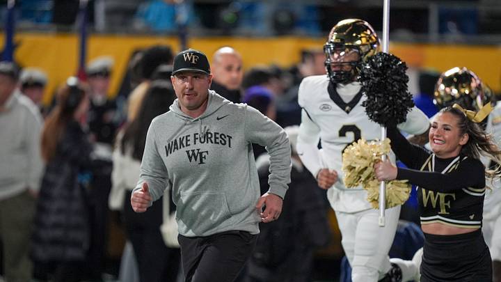 Jan 2, 2026; Charlotte, NC, USA;  Wake Forest Demon Deacons head coach Jake Dickert leads his teaM onto the field during the first quarter against the Mississippi State Bulldogs at Bank of America Stadium. Mandatory Credit: Jim Dedmon-Imagn Images