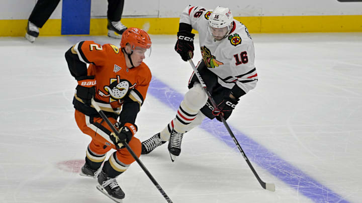 Nov 3, 2024; Anaheim, California, USA;  Anaheim Ducks defenseman Jackson LaCombe (2) and Chicago Blackhawks center Jason Dickinson (16) go for the puck in the first period at Honda Center. Mandatory Credit: Jayne Kamin-Oncea-Imagn Images