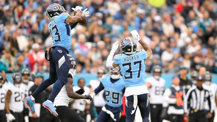 Dec 8, 2024; Nashville, Tennessee, USA;  Tennessee Titans cornerback Chidobe Awuzie (13) intercepts the pass thrown by Jacksonville Jaguars quarterback Mac Jones (10) during the first half at Nissan Stadium. Mandatory Credit: Steve Roberts-Imagn Images