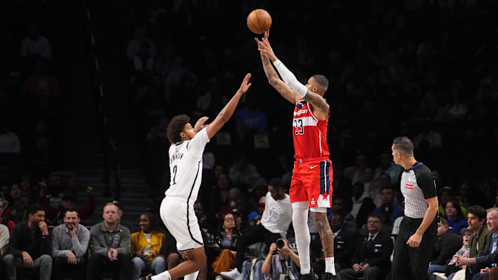 Oct 14, 2024; Brooklyn, New York, USA; Washington Wizards small forward Kyle Kuzma (33) shoots a three-point jump shot over Brooklyn Nets small forward Cameron Johnson (2) during the first half at Barclays Center. Mandatory Credit: Gregory Fisher-Imagn Images