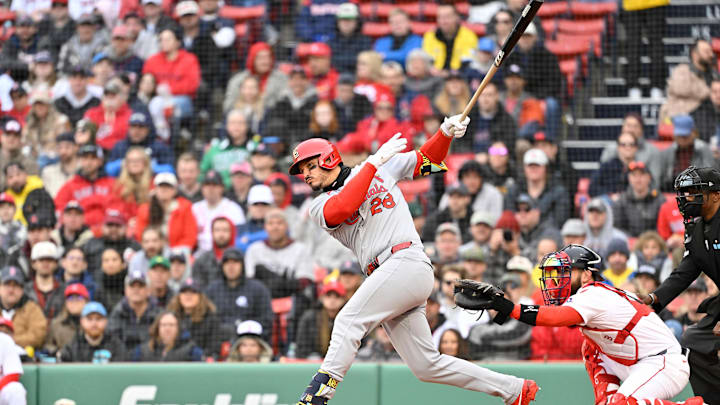Apr 6, 2025; Boston, Massachusetts, USA; St. Louis Cardinals third baseman Nolan Arenado (28) hits a single during the third inning against the Boston Red Sox at Fenway Park. Mandatory Credit: Eric Canha-Imagn Images