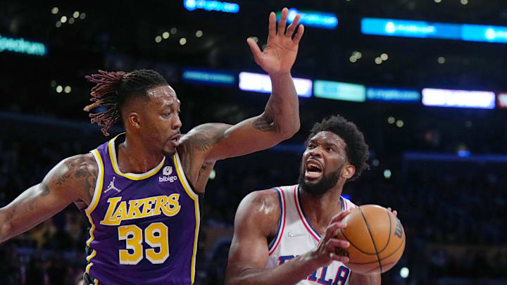Mar 23, 2022; Los Angeles, California, USA; Philadelphia 76ers center Joel Embiid (21) shoots the ball against Los Angeles Lakers center Dwight Howard (39) in the first half at Crypto.com Arena. Mandatory Credit: Kirby Lee-Imagn Images