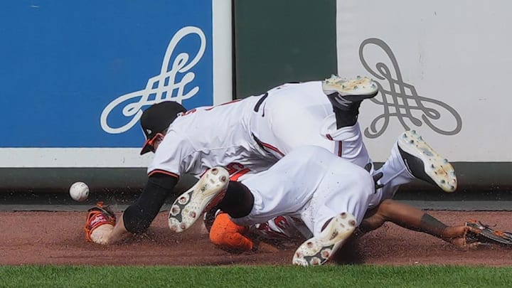Sep 19, 2024; Baltimore, Maryland, USA; Baltimore Orioles outfielders Cedric Mullins (31) and Austin Slater (15) run into each other attempting to catch a ball in the ninth inning against the San Francisco Giants at Oriole Park at Camden Yards. Mandatory Credit: Mitch Stringer-Imagn Images