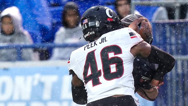 Cincinnati Bearcats safety Antwan Peek Jr. (46) tackles Navy Midshipmen fullback Alex Tecza (46) in the first quarter of the AutoZone Liberty Bowl game between the Cincinnati Bearcats and Navy Midshipmen, Friday, Jan. 2, 2026, at Simmons Bank Liberty Stadium in Memphis, Tn. Cincinnati Bearcats safety Antwan Peek Jr. (46) tackles Navy Midshipmen fullback Alex Tecza (46) in the first quarter of the AutoZone Liberty Bowl game between the Cincinnati Bearcats and Navy Midshipmen, Friday, Jan. 2, 2026, at Simmons Bank Liberty Stadium in Memphis, Tn.
