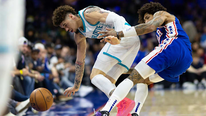 Nov 10, 2024; Philadelphia, Pennsylvania, USA; Charlotte Hornets guard LaMelo Ball (1) and Philadelphia 76ers guard Kelly Oubre Jr. (9) battle for a loose ball before going out of bounds during the first quarter at Wells Fargo Center. Mandatory Credit: Bill Streicher-Imagn Images