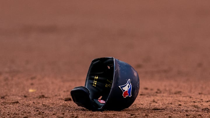 Toronto Blue Jays helmet lays on the infield at an MLB game against the Cleveland Indians at Rogers Centre in 2021.