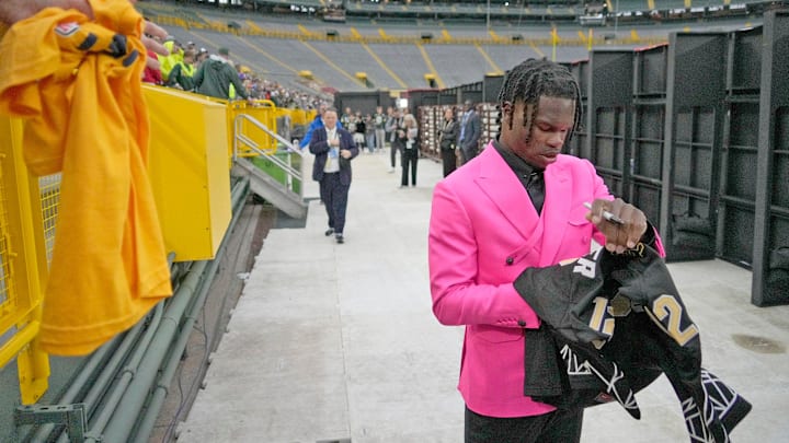 NFL draft prospect, Colorado Buffaloes wide receiver Travis Hunter, signs autographs during the NFL Draft Red Carpet event at Lambeau Field in Green Bay on Thursday, April 24, 2025. NFL draft prospect, Colorado Buffaloes wide receiver Travis Hunter, signs autographs during the NFL Draft Red Carpet event at Lambeau Field in Green Bay on Thursday, April 24, 2025.