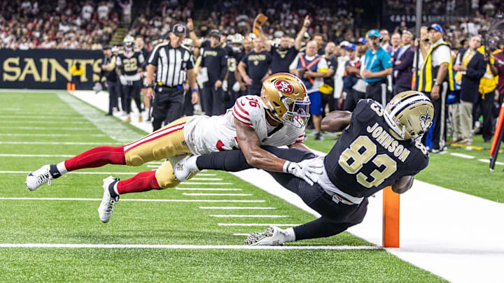 Sep 14, 2025; New Orleans, Louisiana, USA;  New Orleans Saints tight end Juwan Johnson (83) catches a touchdown against San Francisco 49ers safety Marques Sigle (36) during the first half at Caesars Superdome. Mandatory Credit: Stephen Lew-Imagn Images