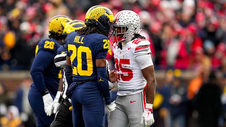 Michigan Wolverines defensive back Jyaire Hill (20) and Ohio State Buckeyes running back Bo Jackson (25) exchange words in the first half of the NCAA football game at Michigan Stadium on Saturday, Nov. 29, 2025 in Ann Arbor, Michigan.