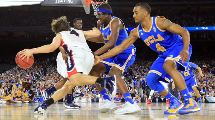 Mar 27, 2015; Houston, TX, USA; Gonzaga Bulldogs guard Kevin Pangos (4) drives past UCLA Bruins guard Norman Powell (4) and forward Kevon Looney (5) during the second half in the semifinals of the south regional of the 2015 NCAA Tournament at Reliant Stadium. Mandatory Credit: Kevin Jairaj-USA TODAY Sports
