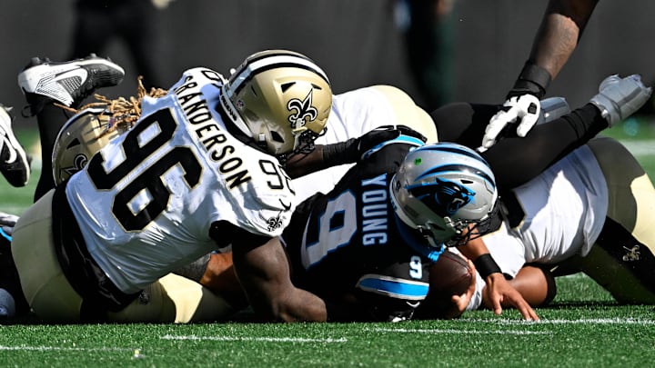 Nov 3, 2024; Charlotte, North Carolina, USA; Carolina Panthers quarterback Bryce Young (9) gets sacked by New Orleans Saints defensive end Carl Granderson (96) in the second qarter at Bank of America Stadium. Mandatory Credit: Bob Donnan-Imagn Images
