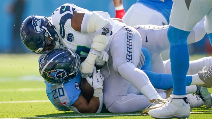 Seattle Seahawks linebacker Uchenna Nwosu (7) tackles Tennessee Titans running back Tony Pollard (20) during the first quarter at Nissan Stadium in Nashville, Tenn., Sunday, Nov. 23, 2025.