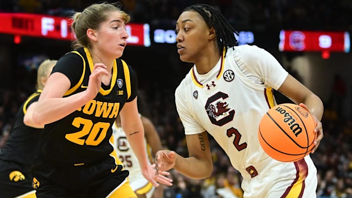 Apr 7, 2024; Cleveland, OH, USA; South Carolina Gamecocks forward Ashlyn Watkins (2) dribbles the ball against Iowa Hawkeyes guard Kate Martin (20) in the finals of the Final Four of the womens 2024 NCAA Tournament  at Rocket Mortgage FieldHouse. Mandatory Credit: Ken Blaze-Imagn Images