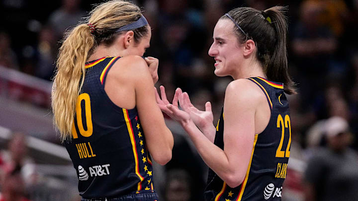 Caitlin Clark (22) and Indiana Fever guard Lexie Hull (10) talk during a timeout.