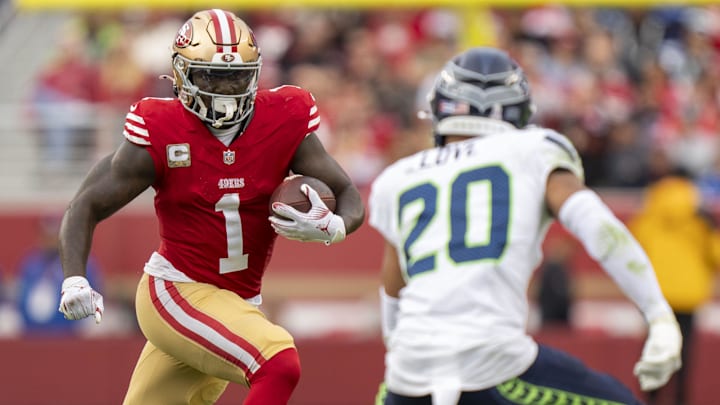 November 17, 2024; Santa Clara, California, USA; San Francisco 49ers wide receiver Deebo Samuel Sr. (1) runs the football against Seattle Seahawks safety Julian Love (20) during the fourth quarter at Levi's Stadium. Mandatory Credit: Kyle Terada-Imagn Images